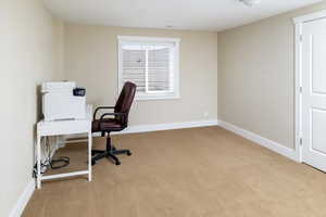 Home office with light colored carpet