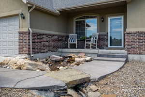 View of exterior entry featuring a porch & waterfall