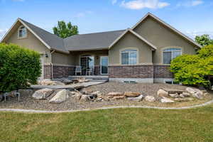 View of front of property with a front lawn with water feature