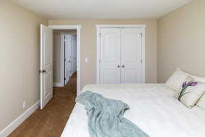 Carpeted bedroom with a closet