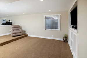 Unfurnished living room featuring a textured ceiling and carpet floors