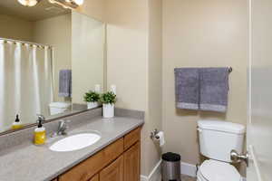 Bathroom with large vanity and toilet