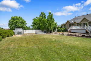 View of yard with a deck & garden area