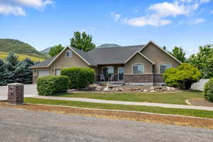 View of front facade featuring a garage and a mountain view