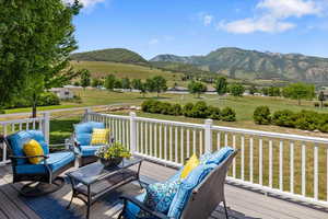 Deck featuring an outdoor living space, a mountain view, a rural view, and a lawn with view of community playground & picnic area