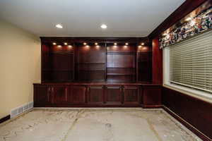 Interior Cherry cabinets and shelves.  Can be a bedroom but a second office/ hobbyist would be great too. (Price adjusted so buyers can customize flooring to their preference after closing.)