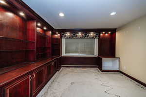 Cherry cabinets and shelves.  Can be a bedroom but a second office/ hobbyist would be great too. (Price adjusted so buyers can customize flooring to their preference after closing.)