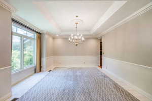 Formal dining room off foyer with side hallway to butlers pantry and into the kitchen. Marble accent with inlaid carpet.