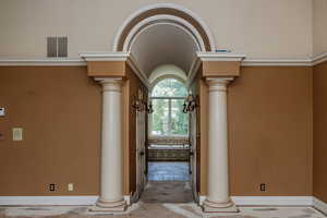 Details featuring tile flooring and decorative columns, entering the 2 walk-in closets and then a peak at the bathroom suite. (Price adjusted so Hallway and closets flooring can be customized to new owners preferences. )