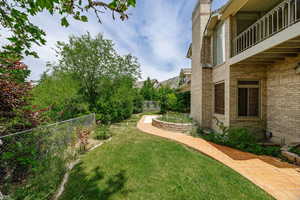 View of backyard, passing the grandious stone planter.