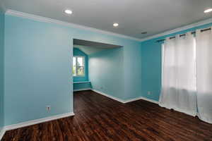 Bedroom with crown molding and LPV flooring.