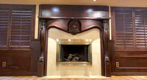 Wood shutter bank the stone fireplace (gas) and the impressive carvings with a full mantle.