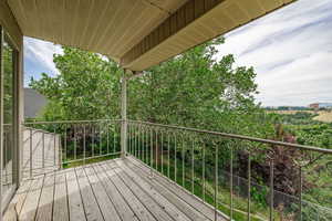 View off balcony.  Back yard  with patio below that's off the kitchen.