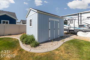 View of shed / structure featuring a yard