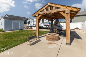 View of patio / terrace with a storage unit and a fire pit