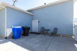 Rear view of property featuring a patio entrance into cover downstair entrance