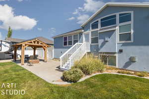 View of front of house with a patio, a front yard, and a gazebo