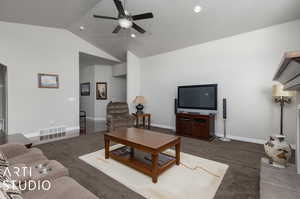 Living room featuring high vaulted ceiling and ceiling fan