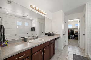 Bathroom featuring a wealth of natural light, tile flooring, and vanity