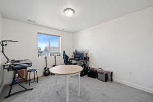 Home office with light colored carpet