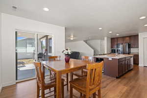 Dining space featuring wood-type flooring and sink