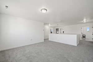 Unfurnished living room featuring carpet flooring