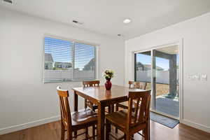 Dining space with plenty of natural light and wood-type flooring