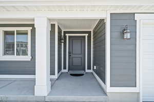 Entrance to property featuring covered porch