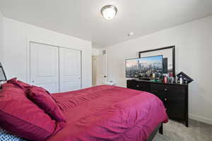 Bedroom with a closet and light carpet