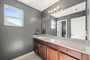 Bathroom featuring tile floors, a wealth of natural light, large vanity, and toilet