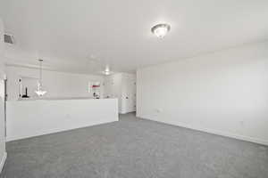 Unfurnished living room with dark colored carpet