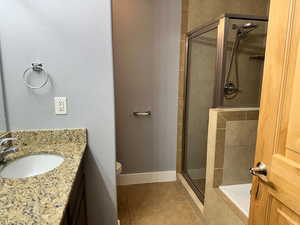 Full bathroom featuring tile patterned flooring, separate shower and tub, toilet, and vanity