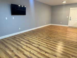 Unfurnished room with hardwood / wood-style floors