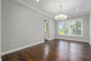 Formal dining room. Door leads to coffee bar, sink, walk-in pantry pass-thru to kitchen