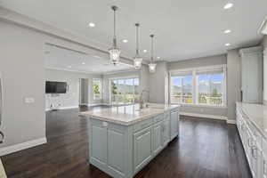 Main floor kitchen looking into family room/den. Sliding doors to deck