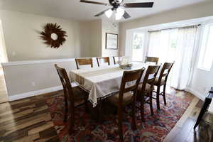 Dining room with wood-type flooring and ceiling fan