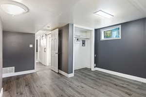 Spare room with a barn door and hardwood / wood-style floors