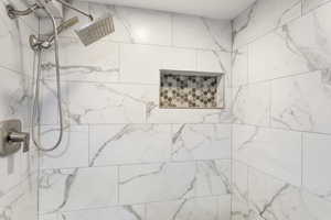 Bathroom featuring a tile shower