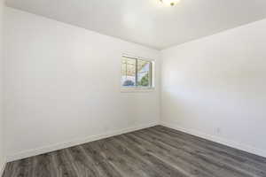 Unfurnished room with dark hardwood / wood-style flooring