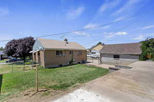 Bungalow-style house with a front yard and a patio