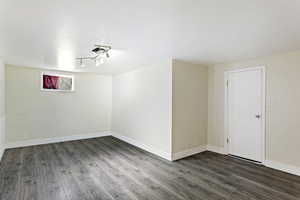 Unfurnished room with dark hardwood / wood-style flooring