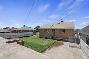 Back of house with a yard, a patio area, and central AC unit