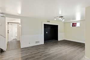 Interior space featuring hardwood / wood-style flooring and rail lighting