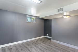 Basement featuring wood-type flooring