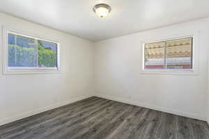 Unfurnished room with dark hardwood / wood-style flooring