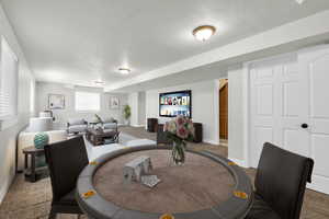 Carpeted dining room with a textured ceiling