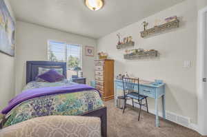 Bedroom featuring a textured ceiling and carpet flooring