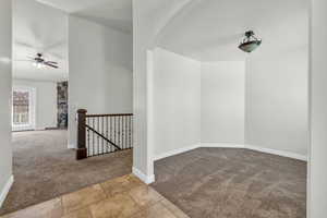 Unfurnished room with light colored carpet and ceiling fan