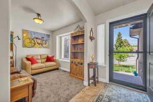 Living room with a wealth of natural light and light colored carpet