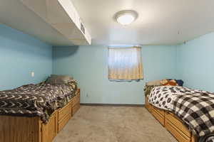 Bedroom featuring light colored carpet